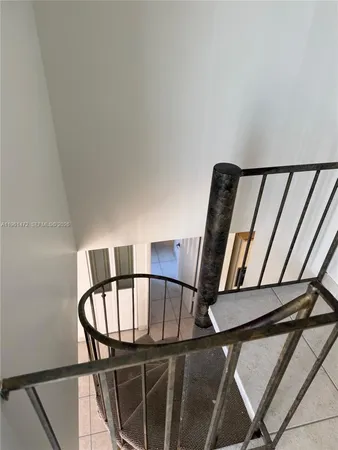 a view of staircase with a rug
