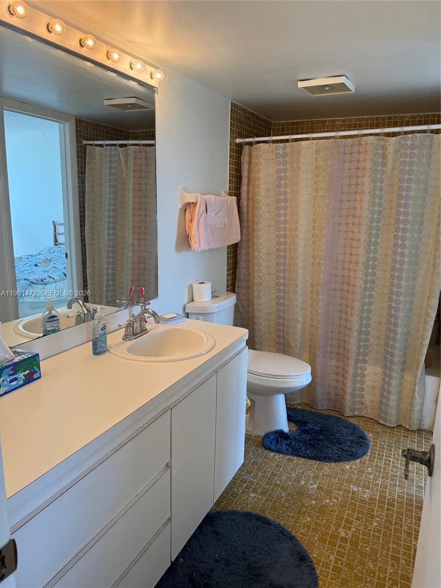 2500 Southwest 122nd Court Miami, FL 33175 - Photo 13 of 19 a bathroom with a sink toilet a mirror and shower curtain