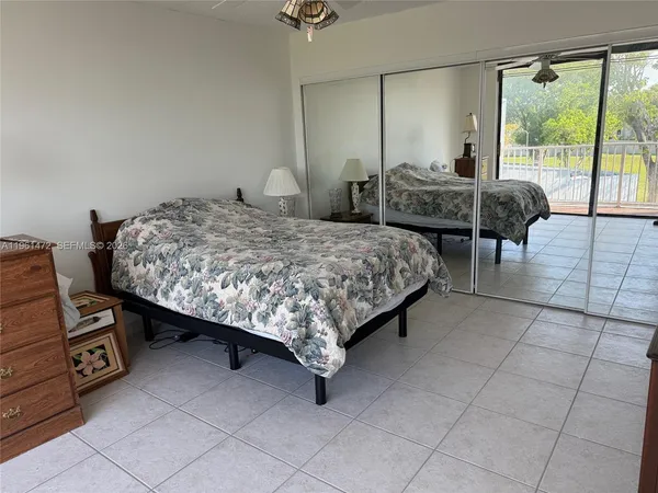 a bedroom with a bed a table and chair