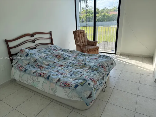 a bedroom with a bed and window