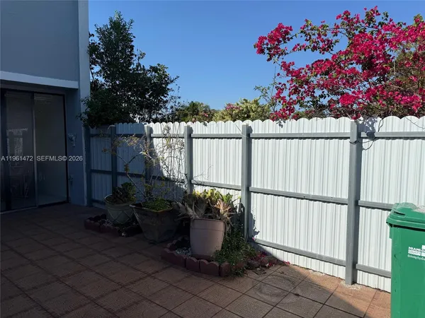 a garden with flowers and wooden fence