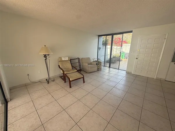 a living room with furniture and a floor to ceiling window