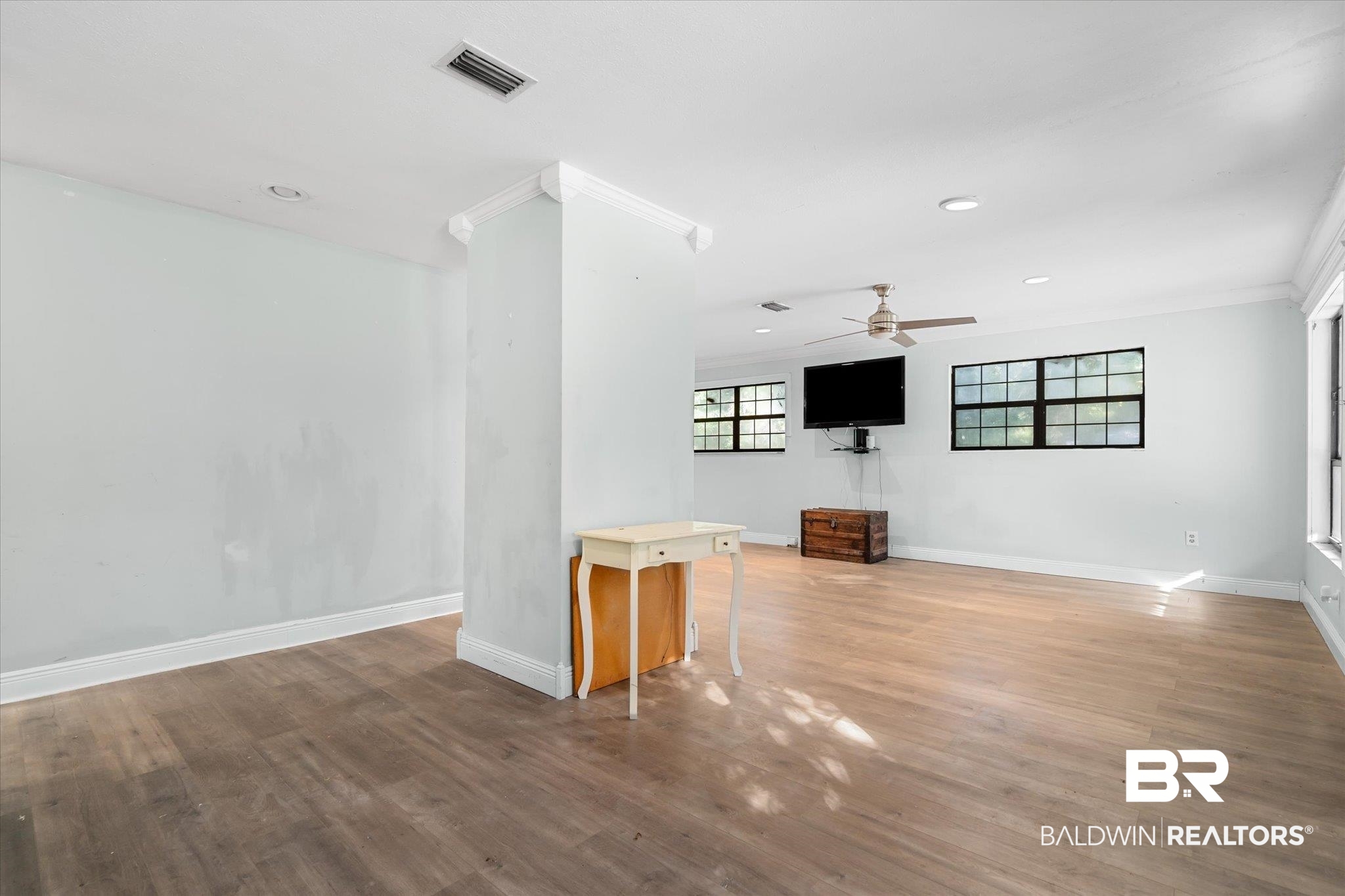 6233 Ponder Road Fairhope, AL 36532 - Photo 6 of 20 Unfurnished living room with hardwood / wood-style flooring, ceiling fan, and ornamental molding