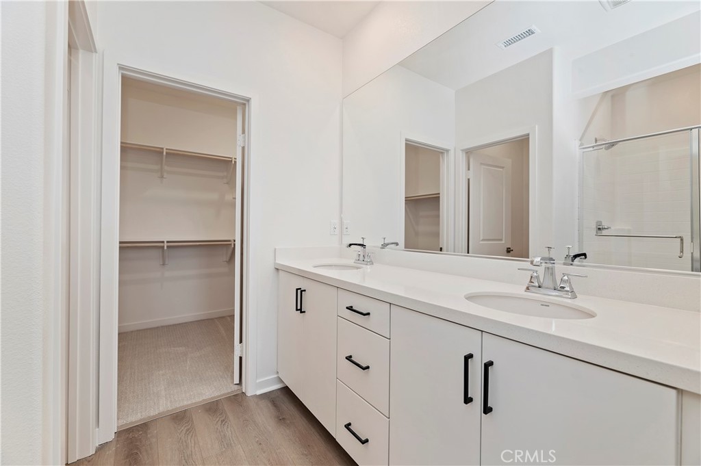 3975 Lavine Way Corona, CA 92883 - Photo 11 of 24 a bathroom with double vanity sink and a mirror