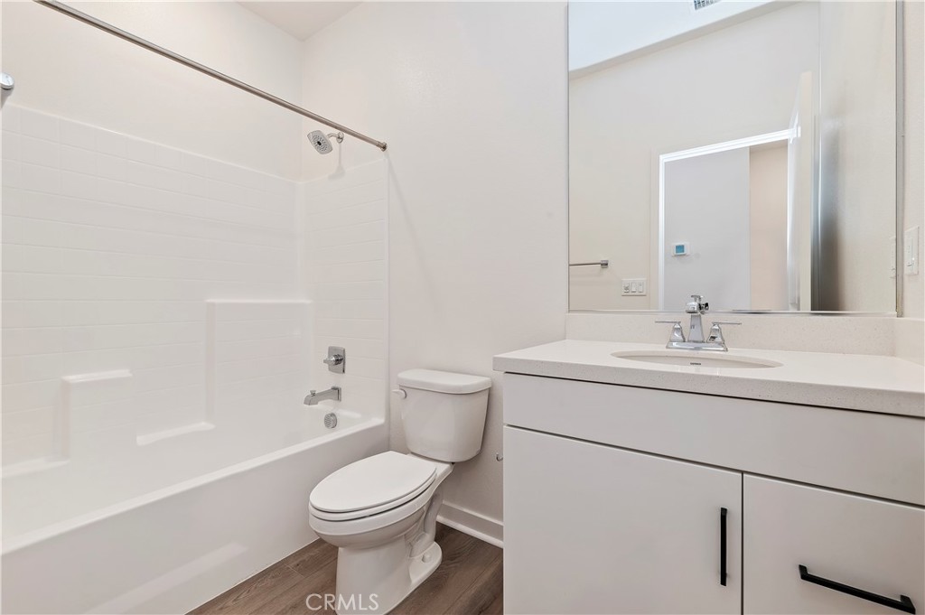 3975 Lavine Way Corona, CA 92883 - Photo 14 of 24 a bathroom with a sink toilet and shower