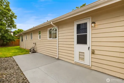 a view of a white house with a garage