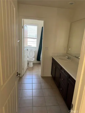 a bathroom with a sink a toilet and a shower