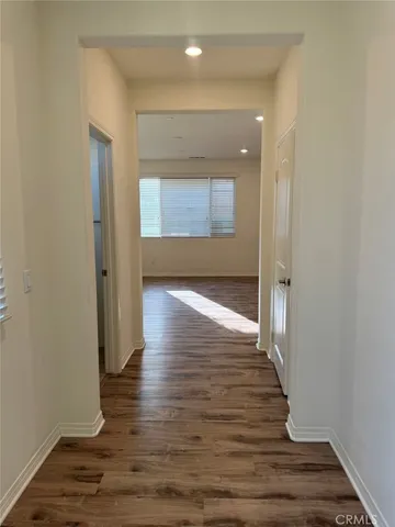a view of hallway with wooden floor