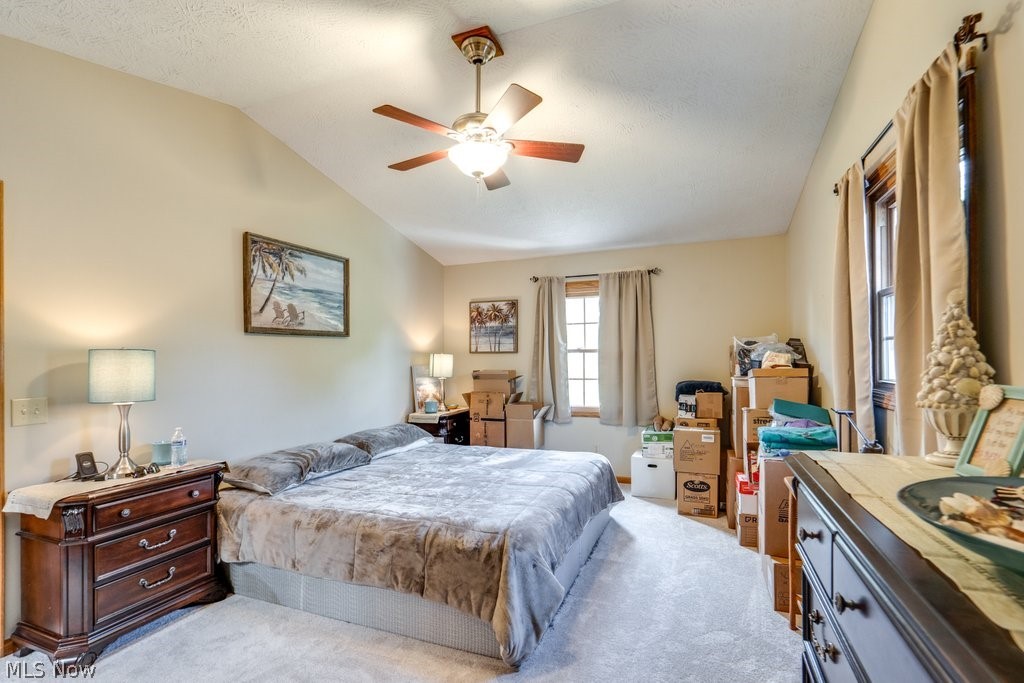 826 Stewart Road Kent, OH 44240 - Photo 31 of 43 Bedroom with a textured ceiling, light carpet, lofted ceiling, and ceiling fan