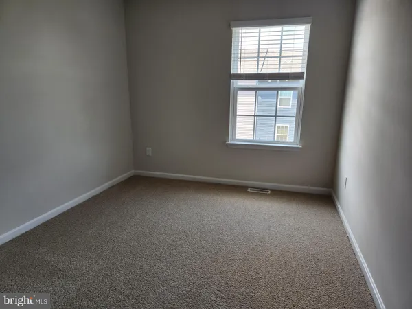 a view of hallway with wooden floor