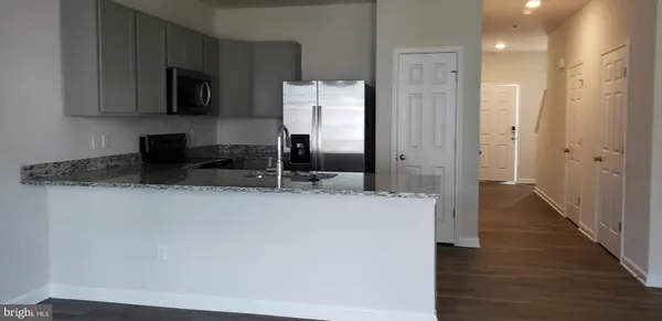 a kitchen with stainless steel appliances a refrigerator a stove a microwave and cabinets