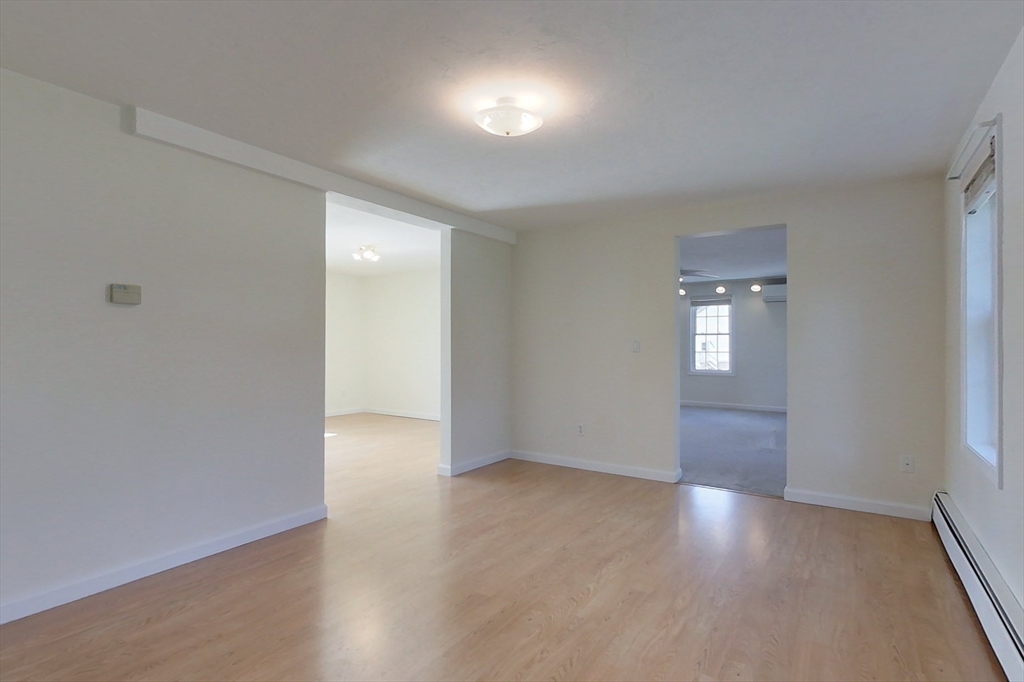 78 Mason Road Townsend, MA 01474 - Photo 12 of 42 a view of an empty room with wooden floor and a window