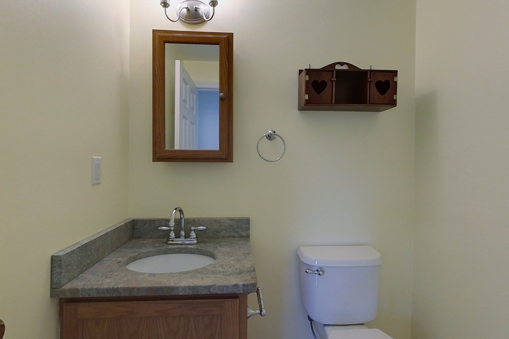 78 Mason Road Townsend, MA 01474 - Photo 18 of 42 a bathroom with a granite countertop toilet sink and mirror