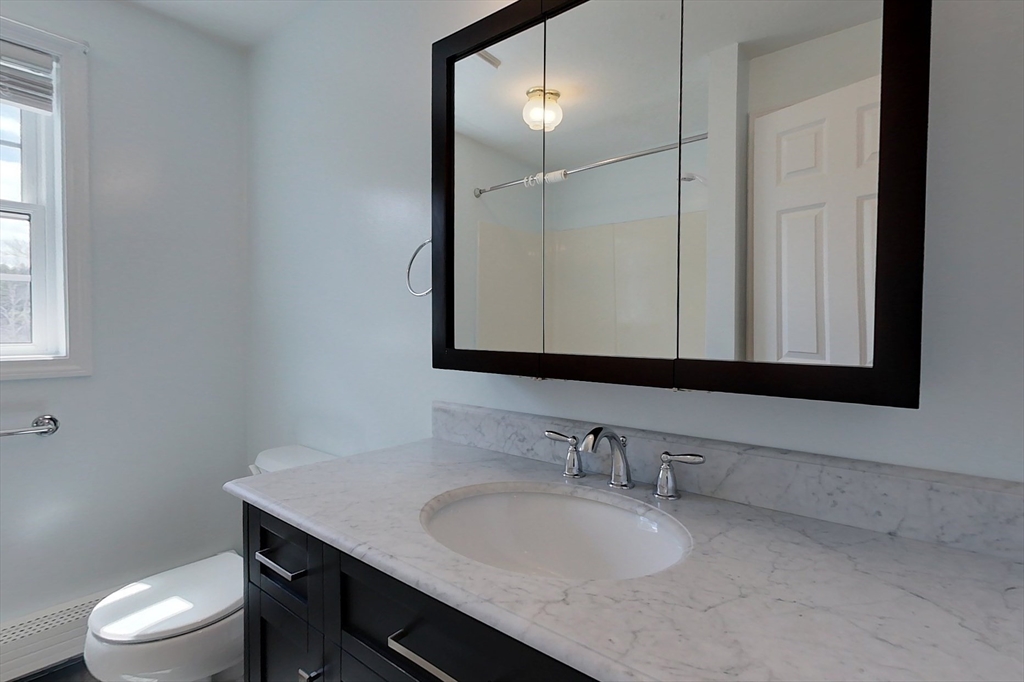 78 Mason Road Townsend, MA 01474 - Photo 30 of 42 a bathroom with a granite countertop sink a toilet and mirror