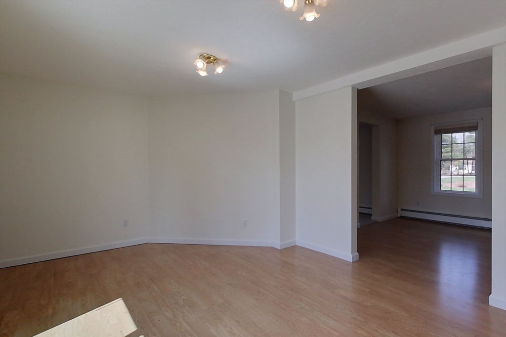 78 Mason Road Townsend, MA 01474 - Photo 8 of 42 a view of an empty room with wooden floor and a window