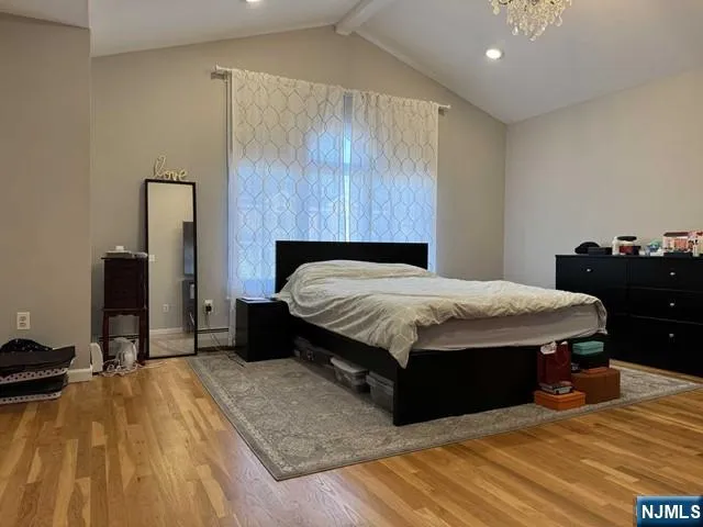 a bedroom with a bed and dresser