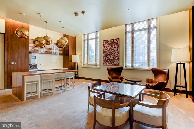 a dining room with furniture and a large window