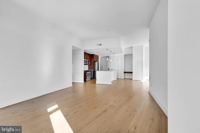 a view of empty room with wooden floor