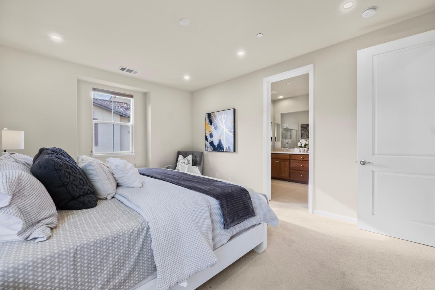 719 Raines Terrace Sunnyvale, CA 94087 - Photo 14 of 47 a large bedroom with a bed and glass windows