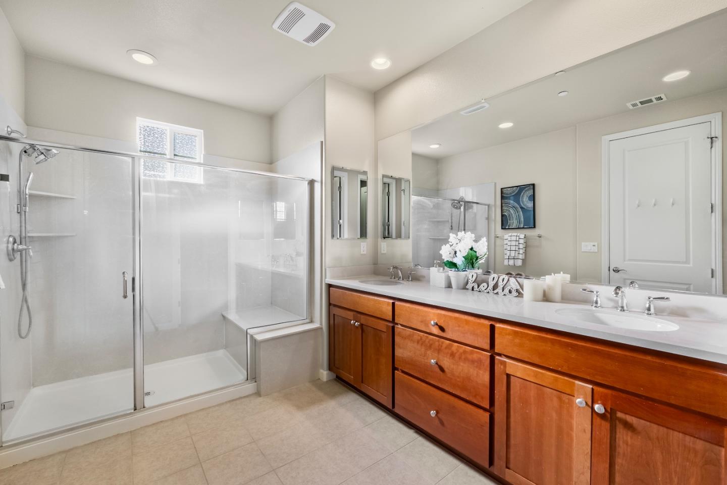 719 Raines Terrace Sunnyvale, CA 94087 - Photo 16 of 47 a bathroom with a granite countertop sink mirror and shower