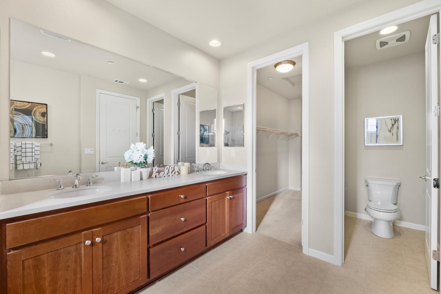 719 Raines Terrace Sunnyvale, CA 94087 - Photo 17 of 47 a spacious bathroom with a granite countertop sink a toilet and a mirror