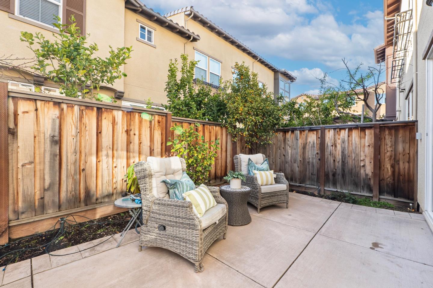 719 Raines Terrace Sunnyvale, CA 94087 - Photo 28 of 47 a view of a patio with a table and chairs and wooden fence