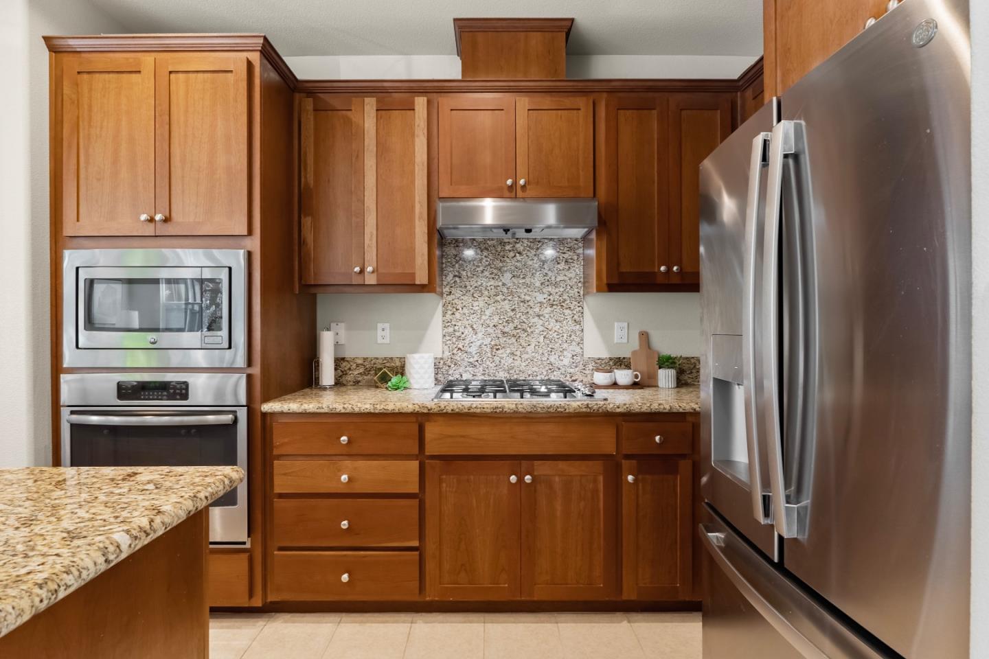 719 Raines Terrace Sunnyvale, CA 94087 - Photo 10 of 47 a kitchen with stainless steel appliances granite countertop a refrigerator and a stove