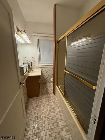 a bathroom with a sink a mirror and shower