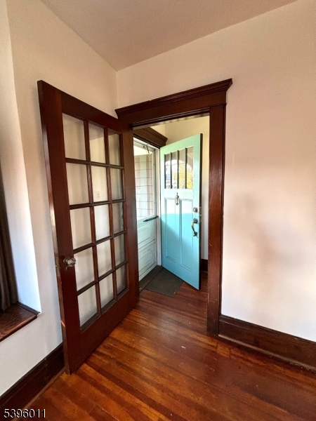 2 Beech Street Cranford, NJ 07016 - Photo 4 of 12 a view of an empty room with wooden floor and a window
