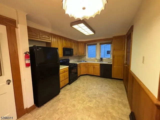 a kitchen with a refrigerator and a sink