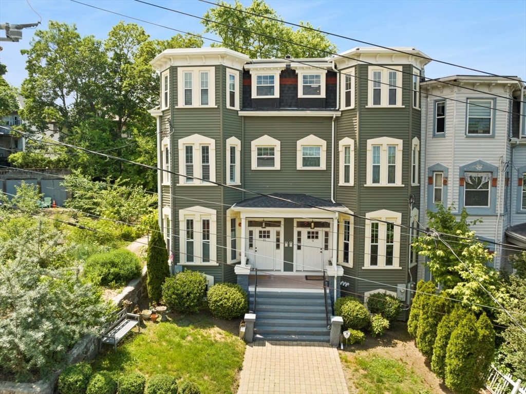 a front view of a residential apartment building with a yard