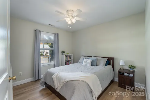 a bedroom with a large bed and a chandelier