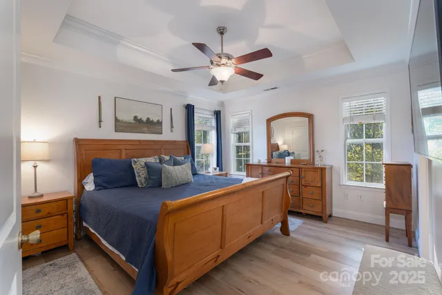 a bed room with a bed and a large window