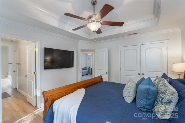 a bedroom with a large bed and a flat screen tv