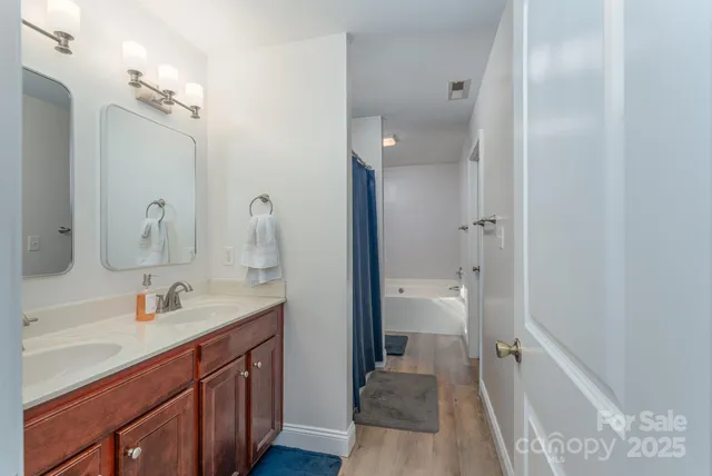a en suite bathroom with a sink double vanity and a mirror