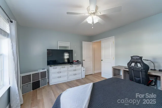 a bedroom with a bed and a flat screen tv