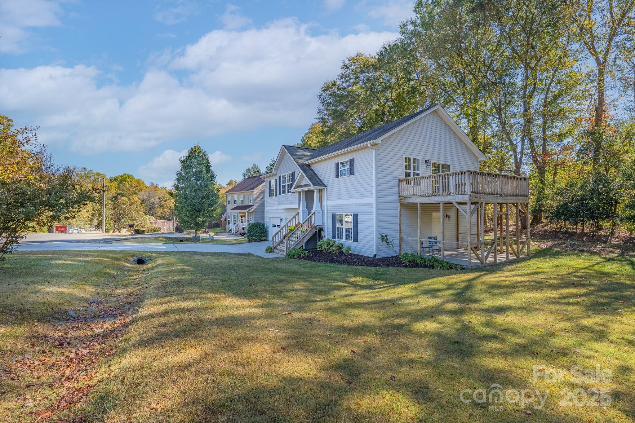 1709 Doves Road Fort Mill, SC 29708 - Photo 3 of 34 a view of a house with a big yard and large trees