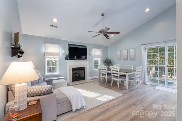 a living room with furniture a fireplace and a flat screen tv