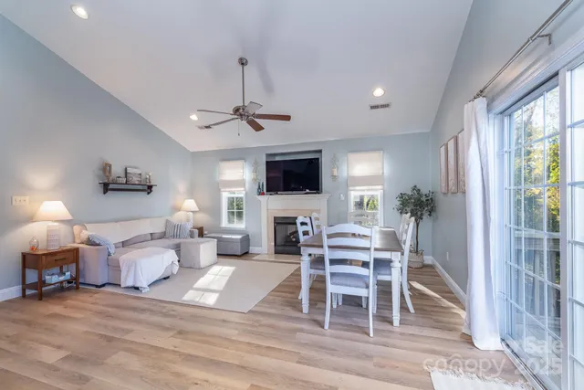 a living room with furniture a flat screen tv and a large window