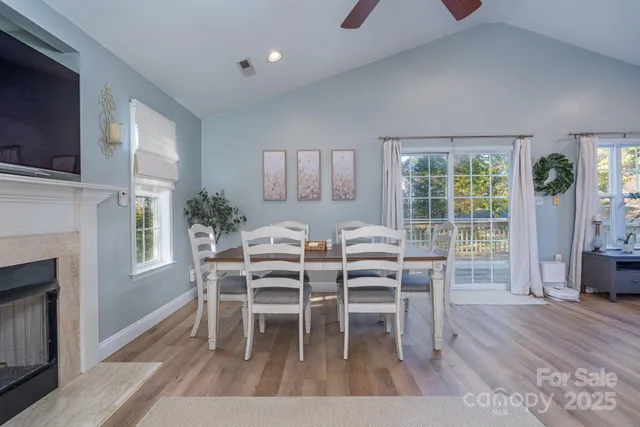 a dining room with furniture and a fireplace or wooden floor