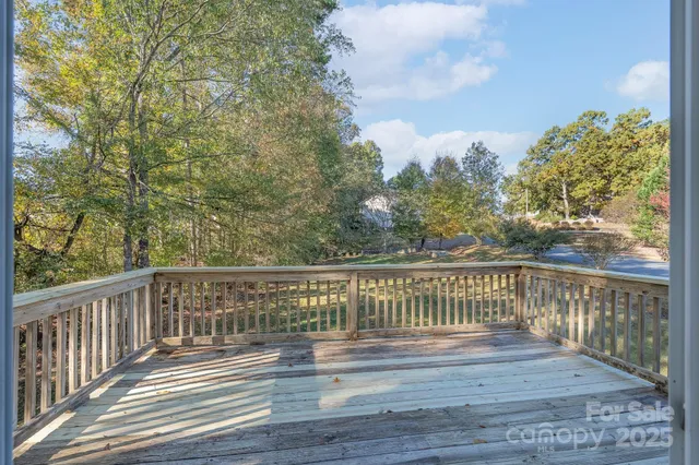 a view of balcony with wooden floor and fence