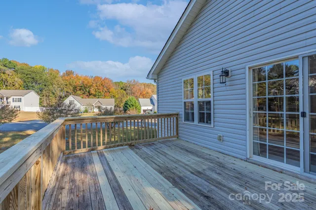 a view of balcony with wooden floor and fence