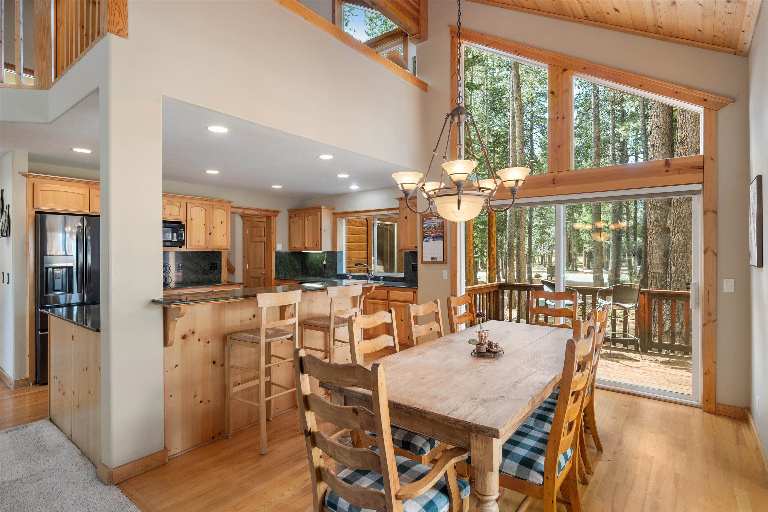 12851 Ski View Loop Truckee, CA 96161 - Photo 11 of 28 a view of a dining room with furniture large windows and wooden floor