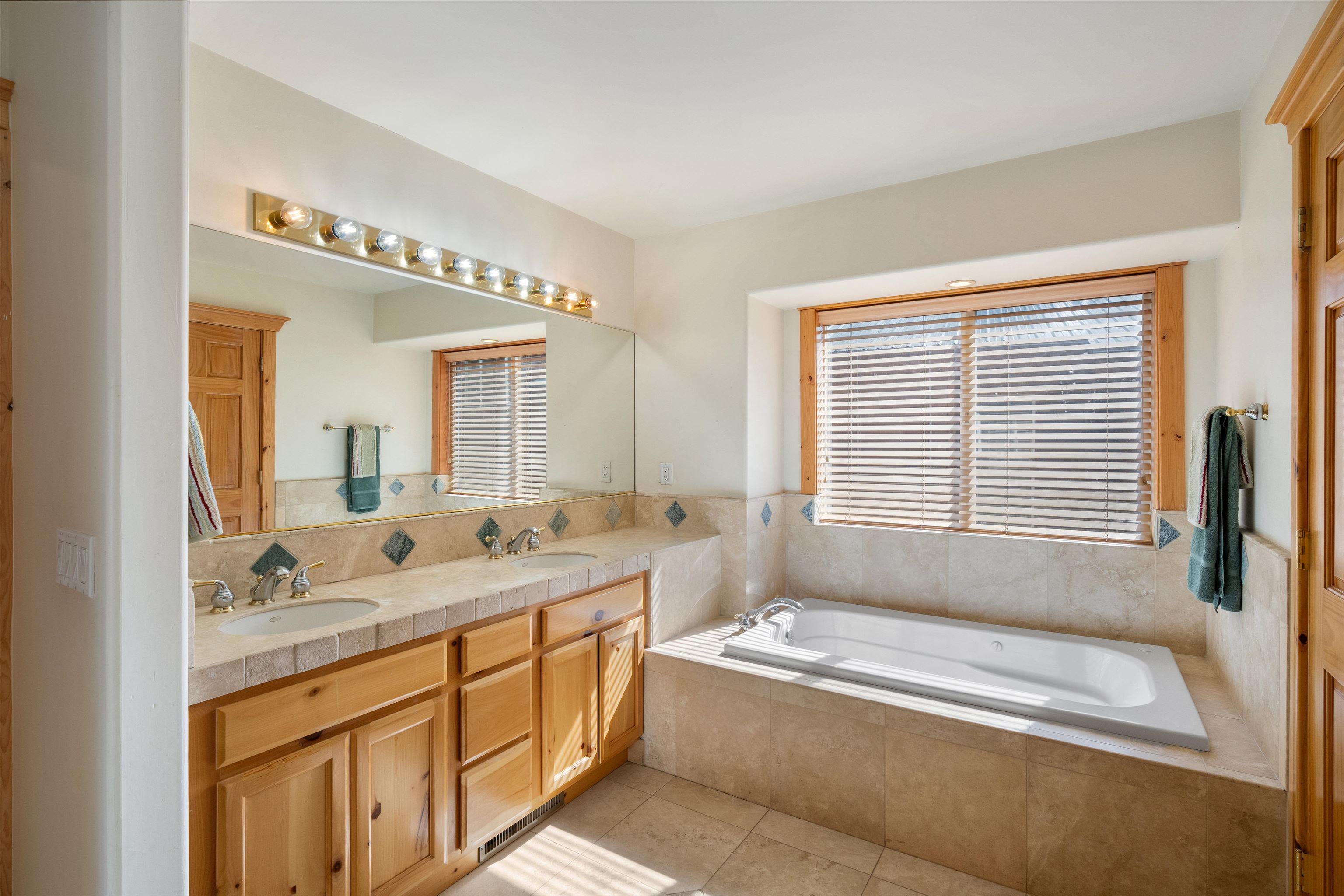 12851 Ski View Loop Truckee, CA 96161 - Photo 15 of 28 a bathroom with a granite countertop tub sink and mirror