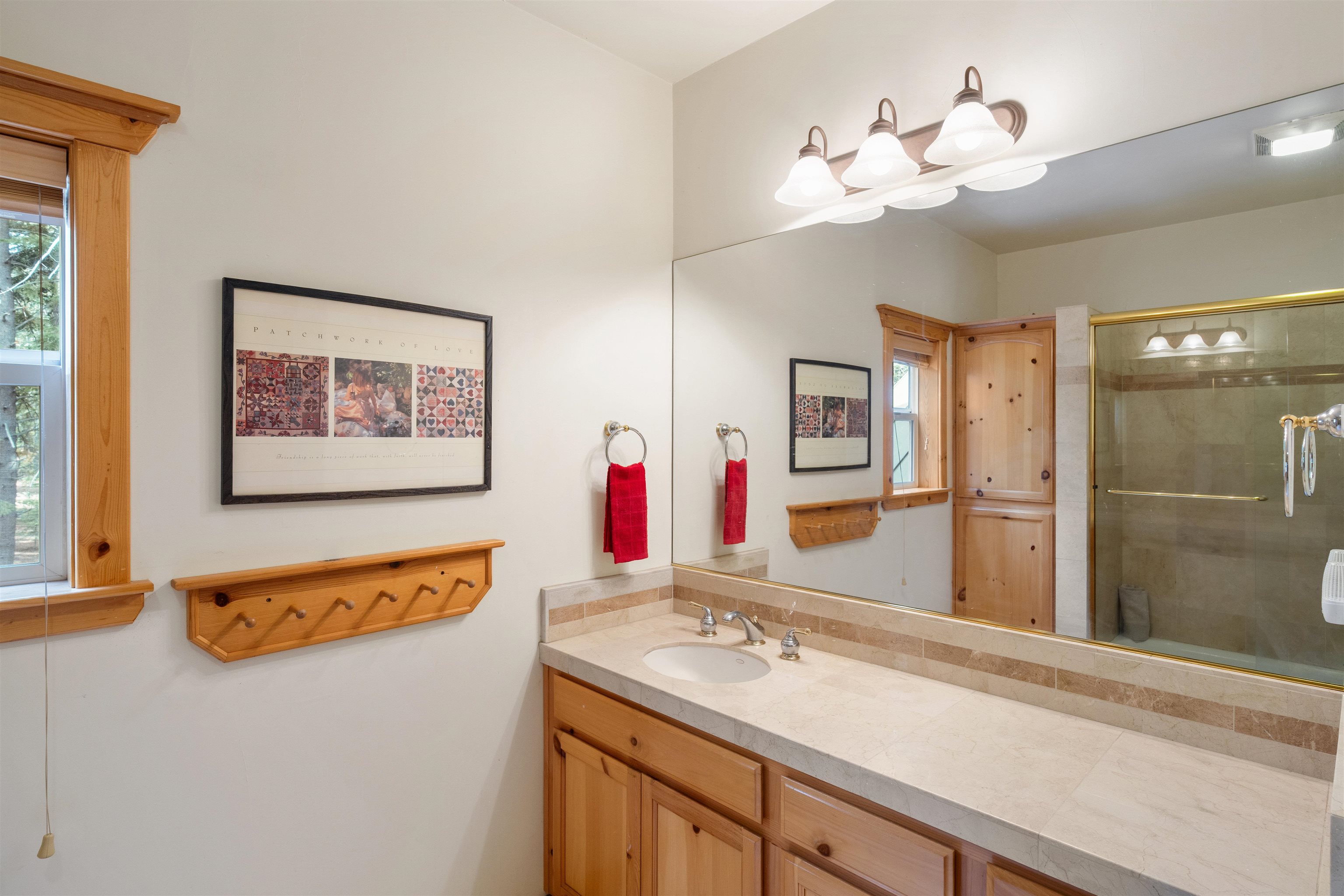 12851 Ski View Loop Truckee, CA 96161 - Photo 20 of 28 a bathroom with a sink a mirror and a shower