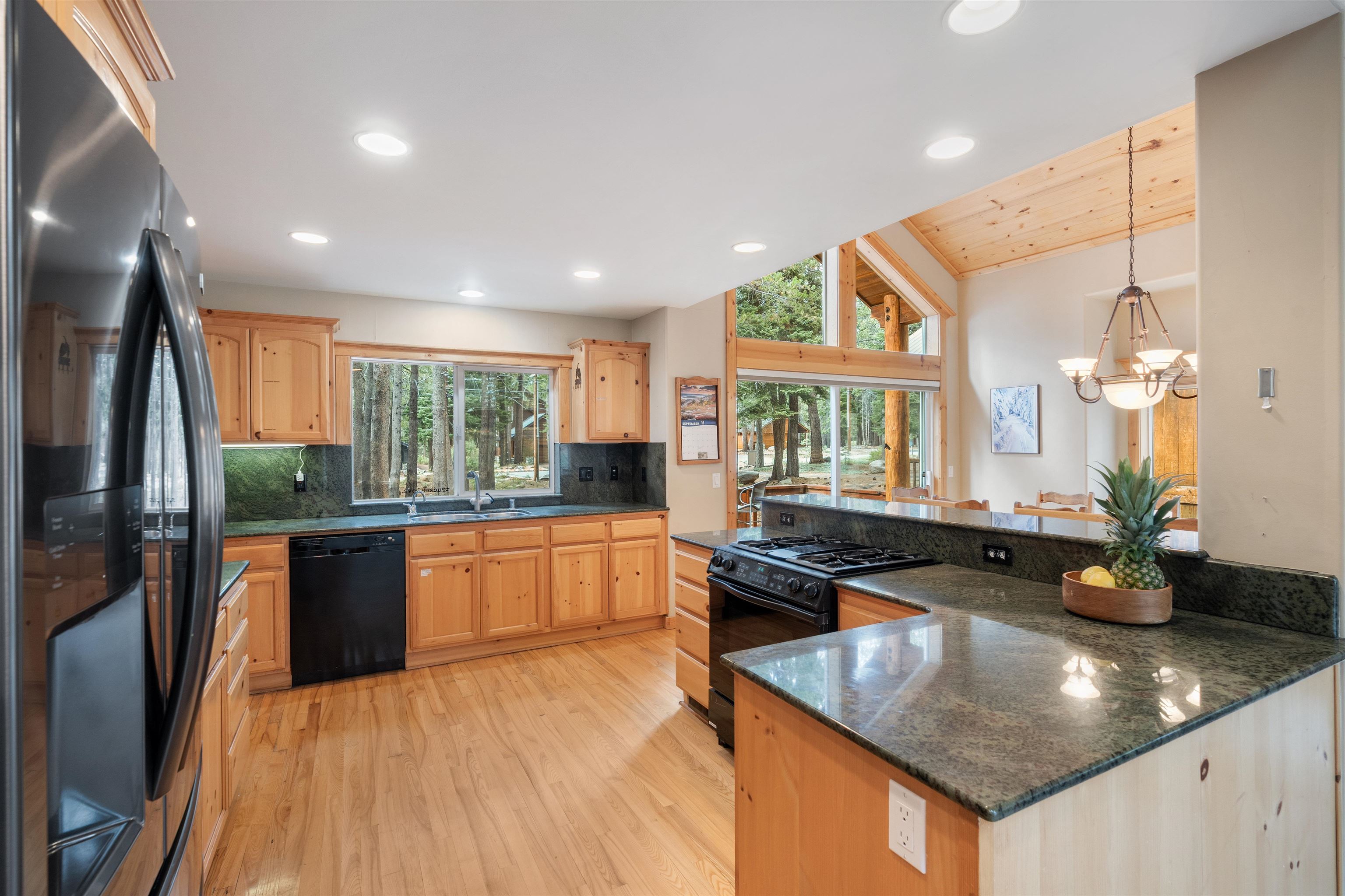 12851 Ski View Loop Truckee, CA 96161 - Photo 8 of 28 a kitchen with granite countertop a sink a counter top space appliances and cabinets