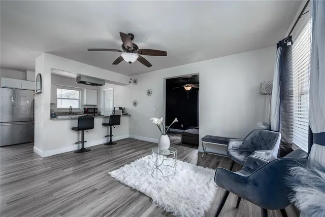a living room with furniture a rug and a chandelier