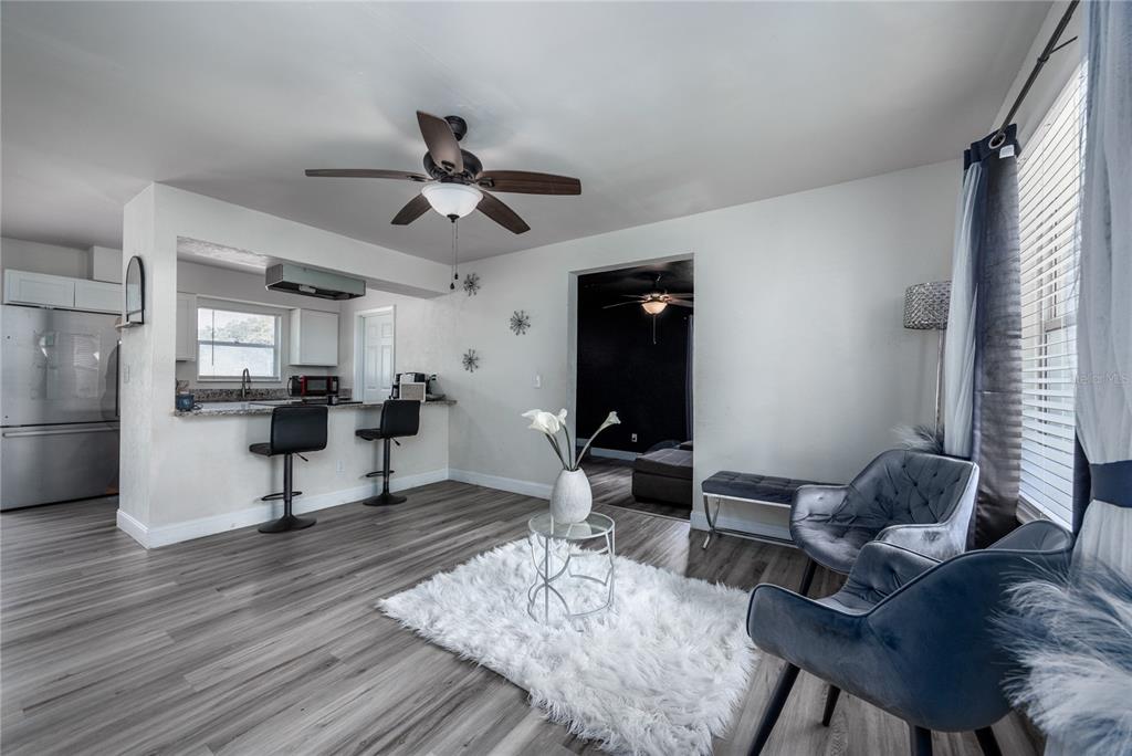 15872 Southwest 133rd Lane Archer, FL 32618 - Photo 13 of 28 a living room with furniture a rug and a chandelier