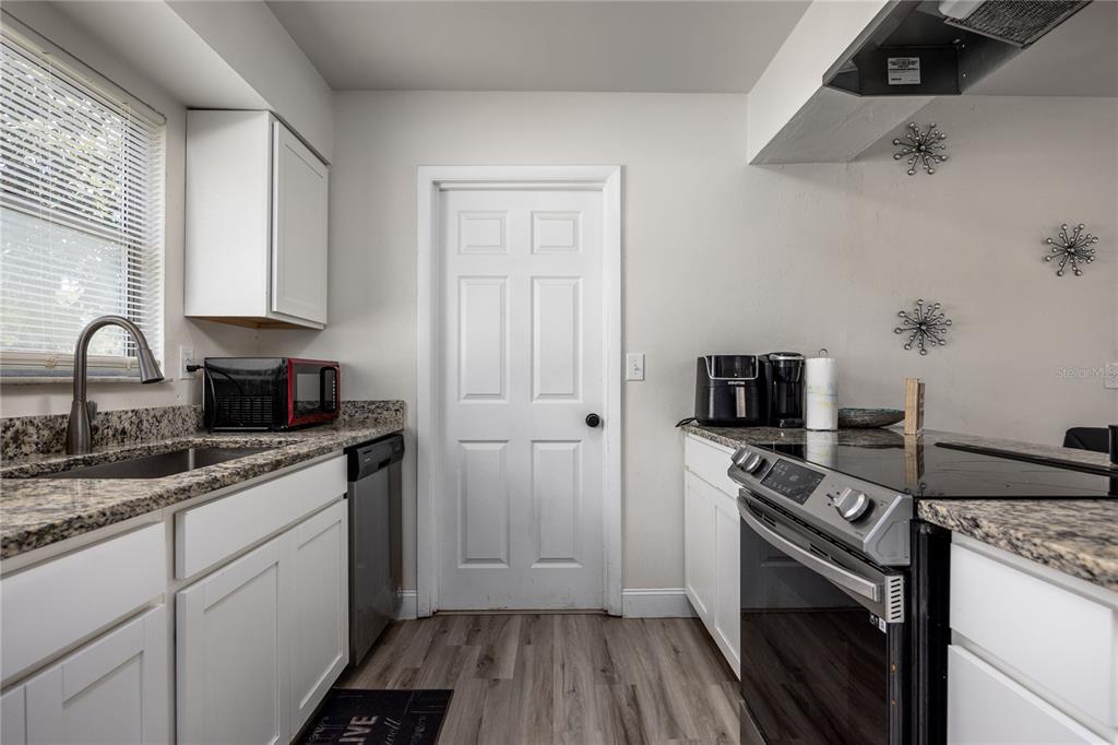 15872 Southwest 133rd Lane Archer, FL 32618 - Photo 18 of 28 a kitchen with a sink stove and refrigerator