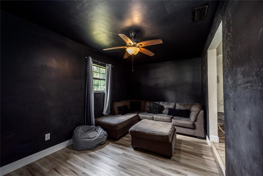 15872 Southwest 133rd Lane Archer, FL 32618 - Photo 23 of 28 a living room with furniture and a chandelier